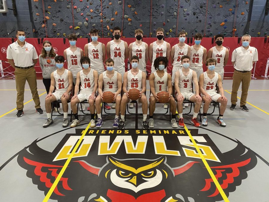 Members of the Varsity Boys Basketball team pose for a photo in their masks. After winning the 2019-2020 NYSAIS title  last year, team members were disappointed when games were canceled this season due to the pandemic.