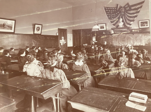 A photograph from the archives of a Friends Seminary classroom from the late nineteenth century. This image shows the separation of boys and girls in the classroom as mentioned in the New York Times article from 1862. 